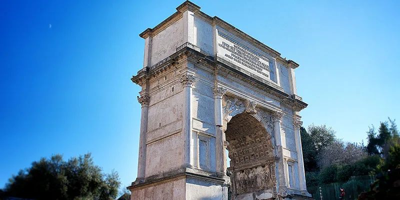Arch of Titus in Roman Forum showcasing ancient Statuario marble craftsmanship